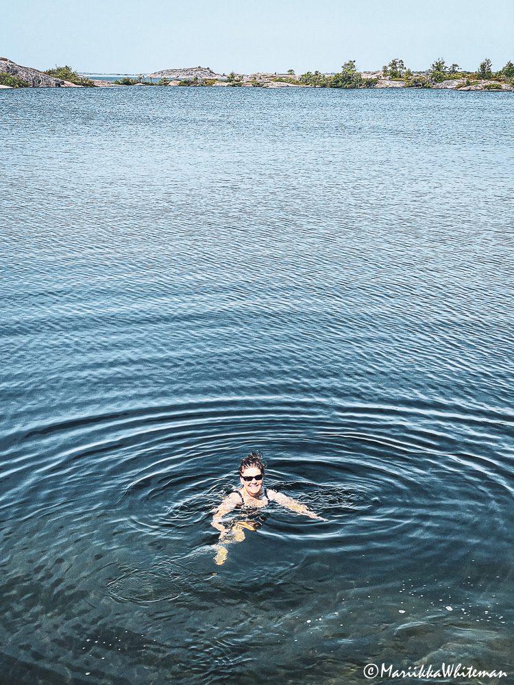 Woman swimming in Björkö lake